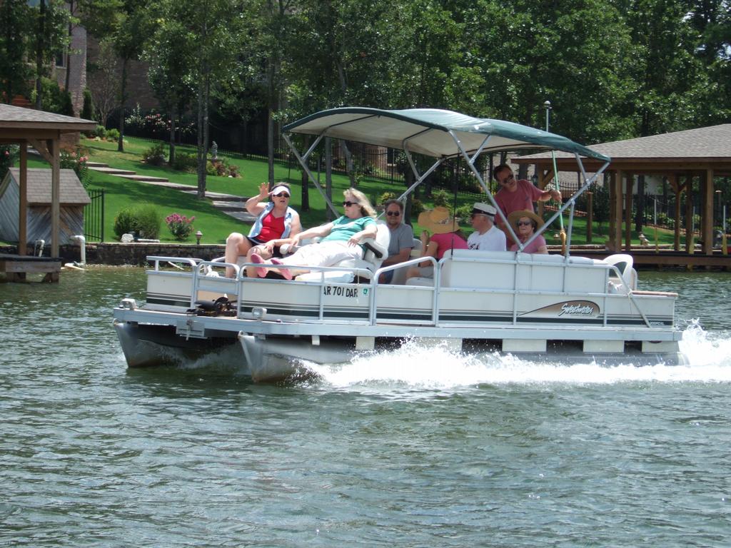 people on pontoon boat on lake from REMAX of Hot Springs Village in Hot Springs Village, AR 71909